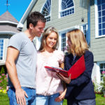 realtor talking with happy couple image