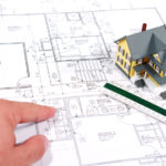 tiny model home on blueprints image